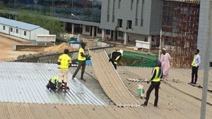 Workers at work on the sector of the roof