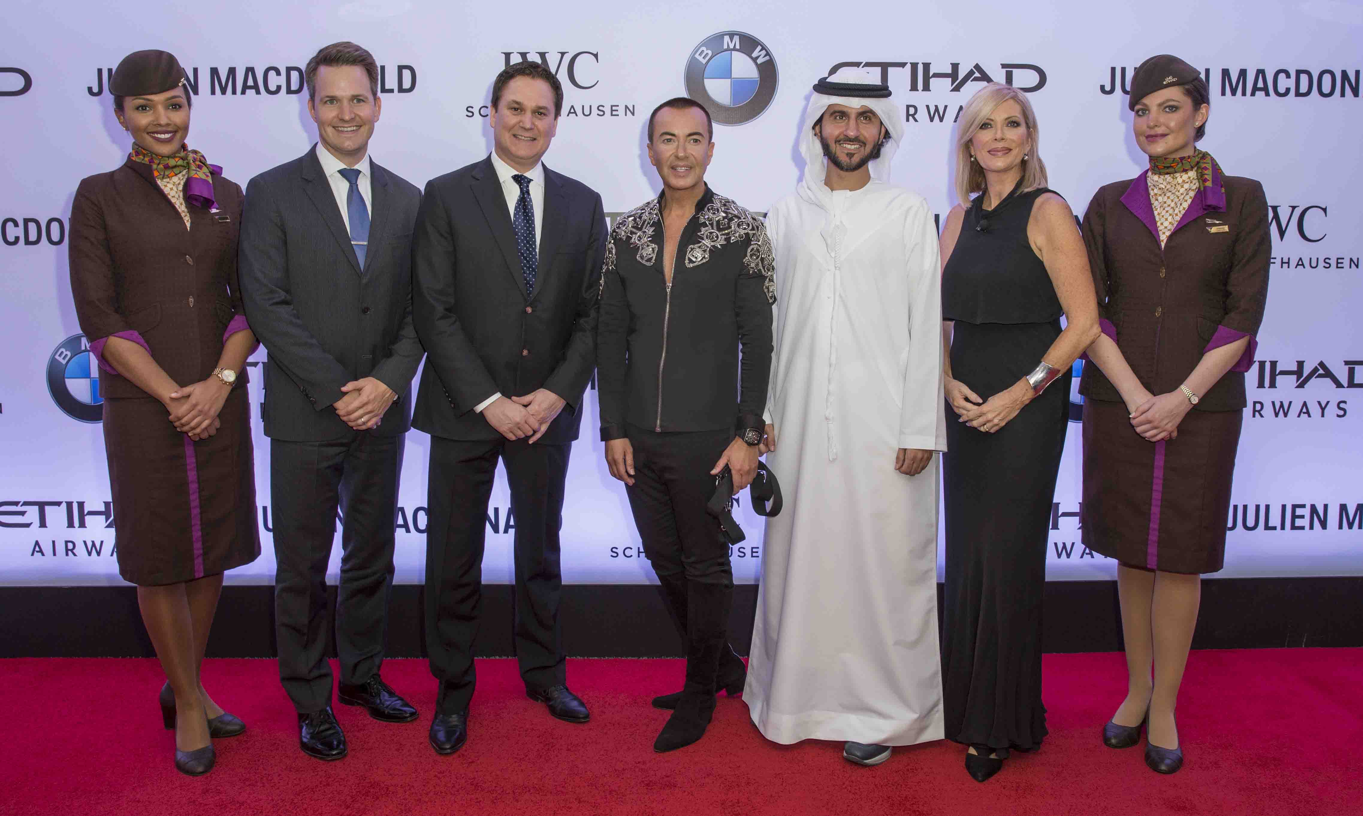 (L-R) Vice President Marketing Partnerships Etihad Airways, Patrick Pierce: Chief Executive Officer, Etihad Airways , Peter Baumgartner; Designer Julien Macdonald OBE; Executive Vice President Commercial, Etihad Airways, Mohammad Al Balooki, , and Etihad Airways Vice President, Guest Experience Delivery, Linda Celestino flanked by members of Etihad Airways’ cabin crew.