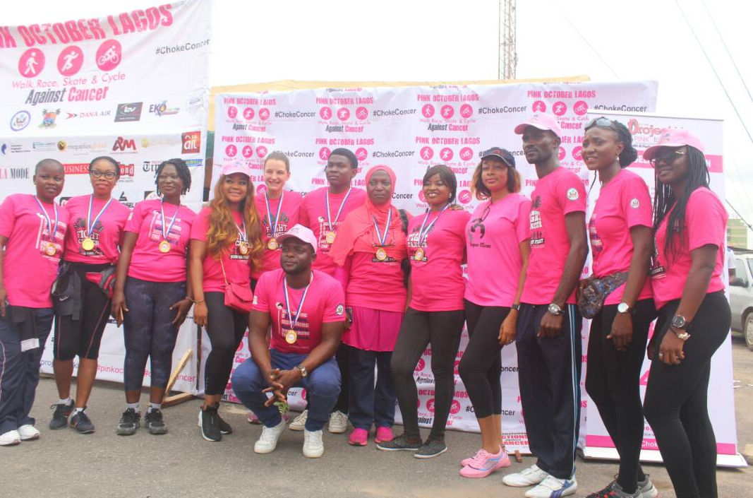 Communications Manager of Dana Air, Kingsley Ezenwa (middle ) with some cancer survivors, celebrities and team members of Project PinkBlue 