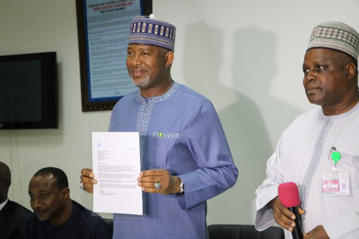 Minister of State, Aviation Sen. Hadi Sirika displaying the letter  letter of United States Federal Airport Administration (US FAA)  Category One Certification after it was presented to him by the Director General of Nigerian Civil Aviation Authority (NCAA) Capt. Mukhtar Usman in Lagos late on Monday.